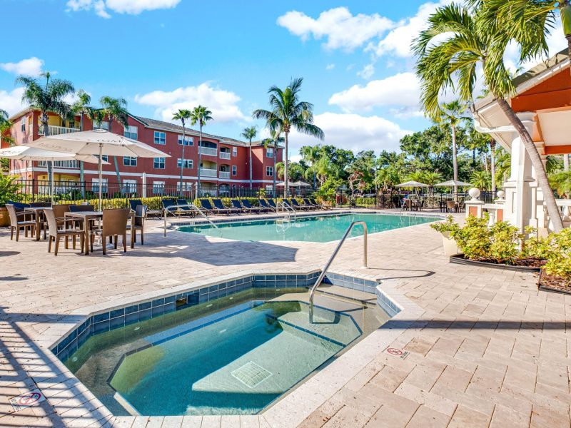 Luxury swimming pool and spa with tropical landscaping at TGM University Park.