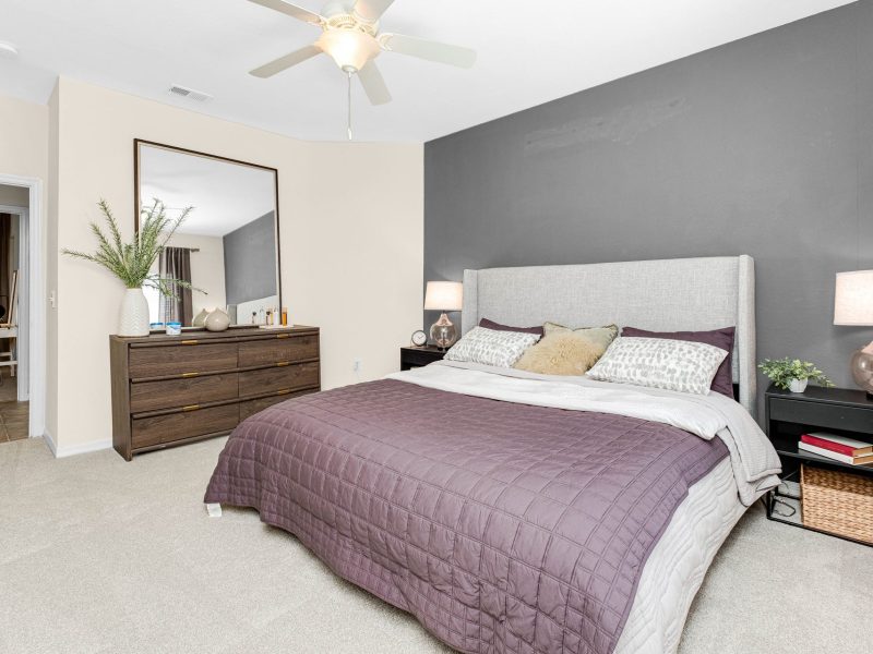 Modern bedroom interior at TGM University Park with stylish bed, dresser, and cozy décor.