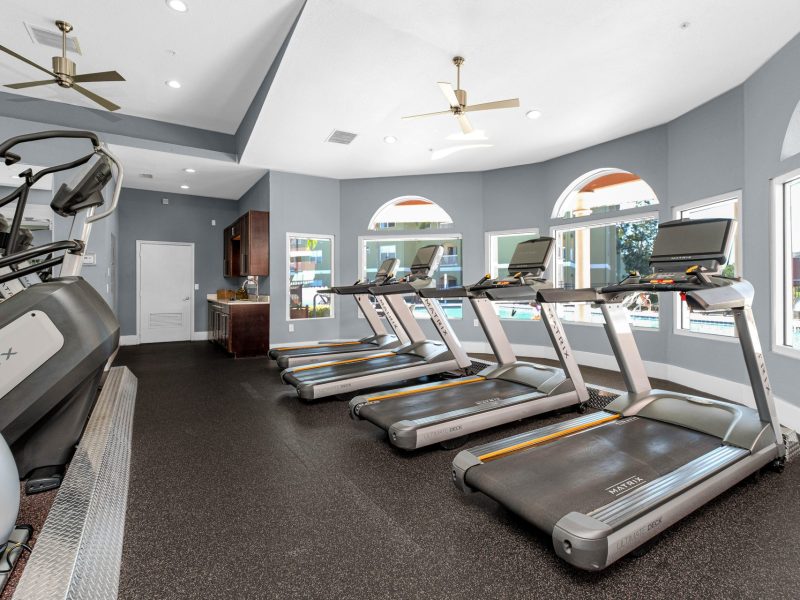 Modern fitness center with treadmills and elliptical at TGM University Park gym.